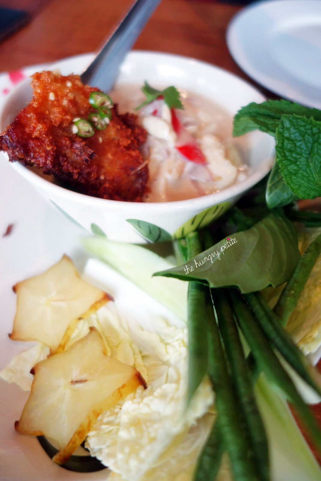 She-Crab Lon: Swimming blue crab meat simmered in coconut cream, shallots, green mango served with fresh veggies and sticky rice cured fish