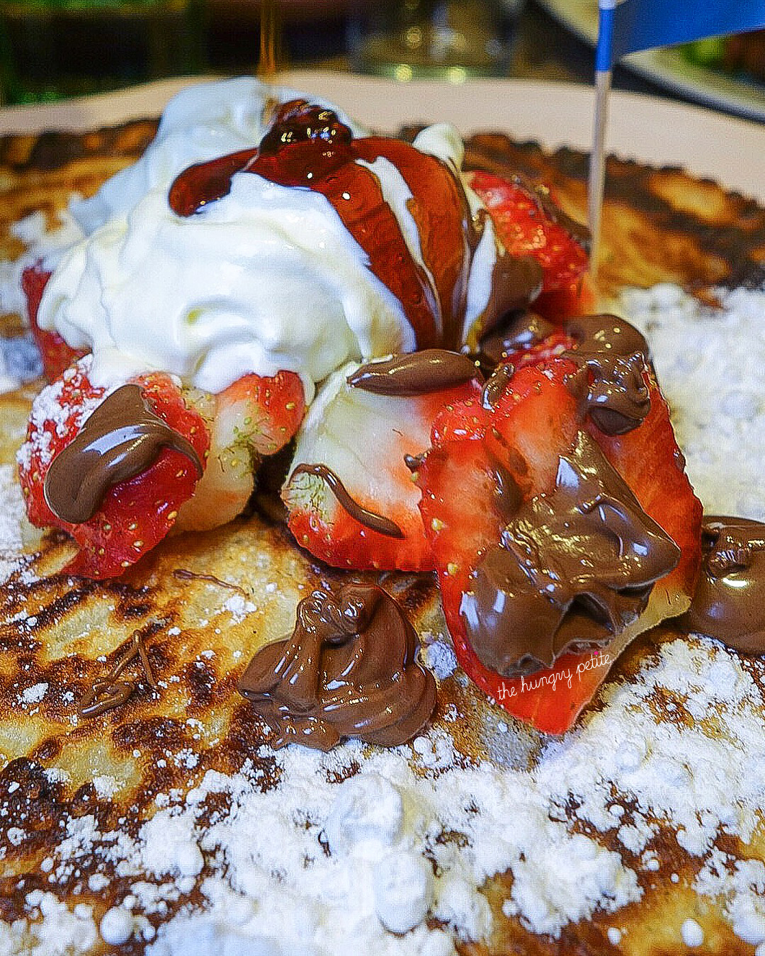 Nutella with strawberries and powdered sugar dutch pancake