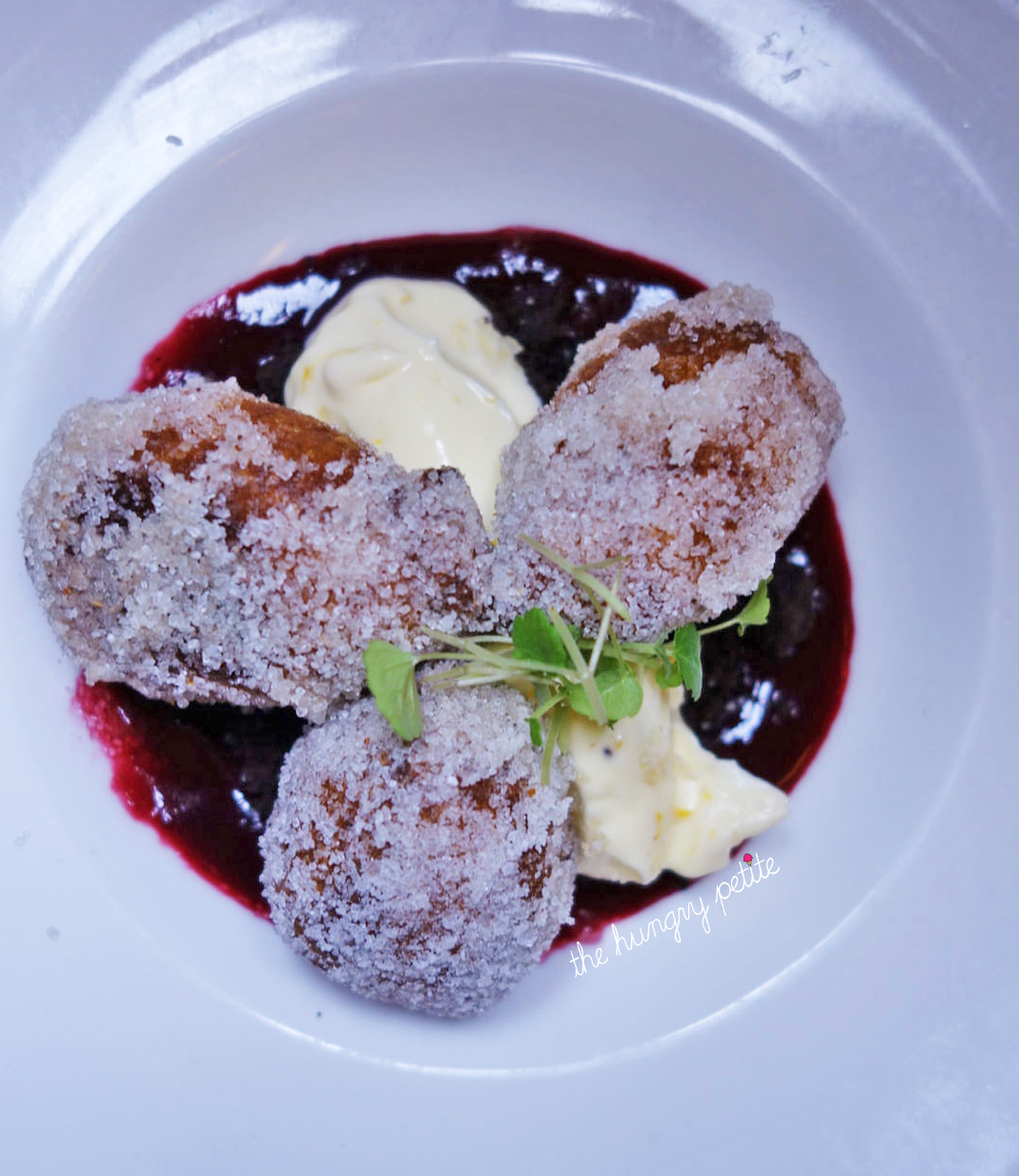 Ricotta beignets with red fruits coulis and creme fraiche