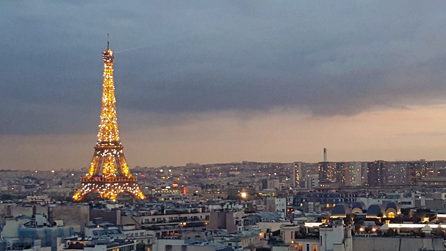 After sunset while the Eiffel Tower is sparkling with lights