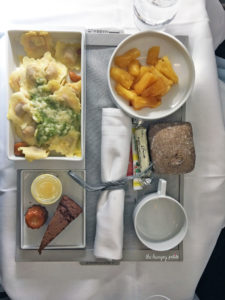 Pasta filled with Mediterranean vegetables, watercress sauce, caramelized pineapple, soft chocolate cake and small pot of crème anglaise