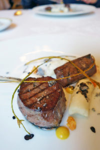 Rib of venison roasted with charcoal, horseradish and mustard, gnocchi.