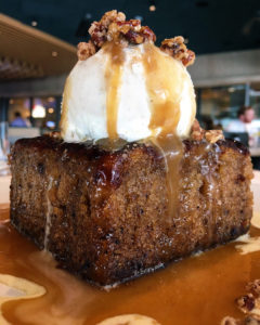 Sticky Toffee Pudding- nutritional information warm, with candied pecans, buttery caramel sauce, bourbon crème anglaise & vanilla bean ice cream. A behemoth of a dessert. You'll definitely want to share this one. $9