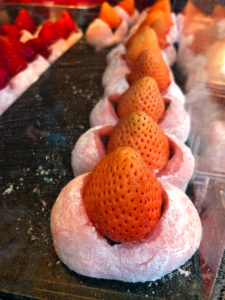Ichigo Daifuku (strawberry mochi). This is available among a lot of street vendors, so you can probably find this easily in Tokyo, Kyoto, Osaka, etc. These are from Tsukiji Market in Tokyo.