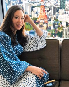 A photo of a woman posing in front of the Tokyo Tower